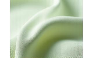 Futuristisk, plantebasert tekstil med subtil tekstur og moderne utseende.